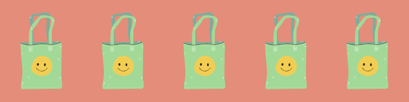 some tote bags with a smiley face on them